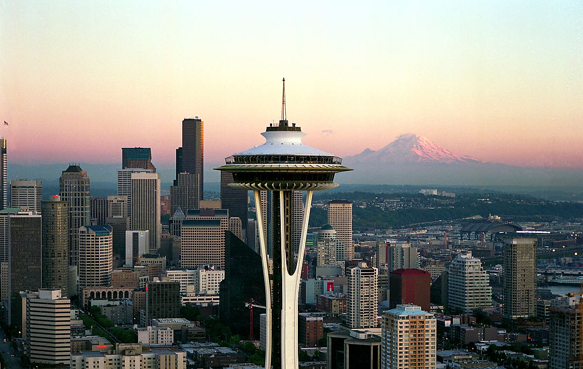 The Space Needle with the Seattle skyline and Mount Rainier at sunset